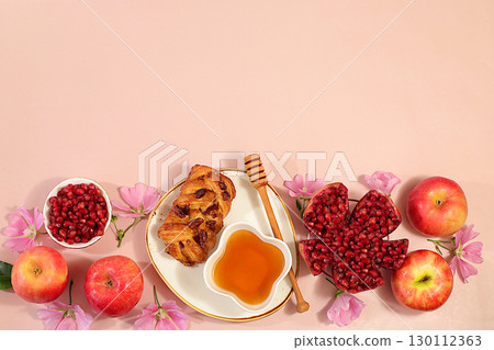 Jewish holiday Rosh Hashanah concept with apples, honey, pomegranate, challah bread and flowers for greeting card, creative layout and template for Jewish New Year and Thanksgiving, autumn banner 130112363