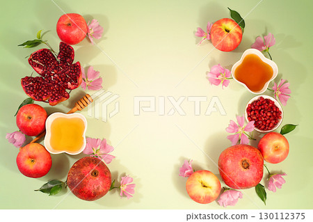 Creative composition for the Jewish holiday Ro Hashanah with a place for congratulations. Layout with traditional symbols of the Jewish New Year, template with honey, apples, pomegranate and flowers Creative composition for the Jewish holiday Ro Hashanah with a place for congratulations. Layout with traditional symbols of the Jewish New Year, template with honey, apples, pomegranate and flowers 130112375