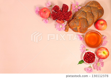 Jewish holiday Rosh Hashanah concept with apples, honey, pomegranate, challah bread and flowers for greeting card, creative layout and template for Jewish New Year and Thanksgiving, autumn banner 130112378