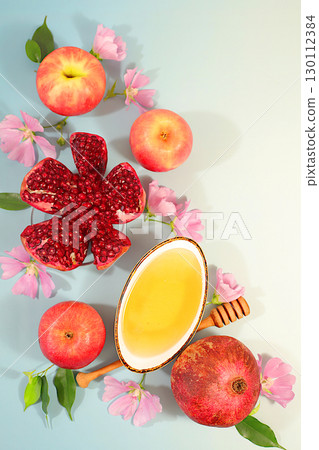 Jewish holiday Rosh Hashanah concept with apples, honey, pomegranate and flowers for greeting card, creative layout and template for Jewish New Year and Thanksgiving, autumn banner for design. 130112384
