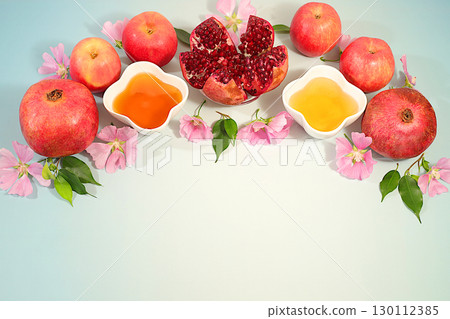Jewish holiday Rosh Hashanah concept with apples, honey, pomegranate and flowers for greeting card, creative layout and template for Jewish New Year and Thanksgiving, autumn banner for design. 130112385