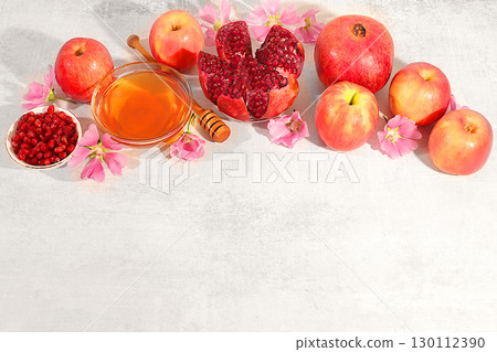 Autumn banner with honey, apples, pomegranates, flowers, dried fruits for holiday greeting, composition for Jewish holiday Rosh Hashanah with traditional symbols, creative layout for design, template Autumn banner with honey, apples, pomegranates, flowers, dried fruits for holiday greeting, composition for Jewish holiday Rosh Hashanah with traditional symbols, creative layout for design, template 130112390