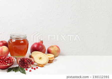 Autumn banner with honey, apples, pomegranates, flowers, dried fruits on a light background with place for text, composition for the Jewish holiday Rosh Hashan, Hello autumn and thanksgiving day Autumn banner with honey, apples, pomegranates, flowers, dried fruits on a light background with place for text, composition for the Jewish holiday Rosh Hashan, Hello autumn and thanksgiving day 130112391
