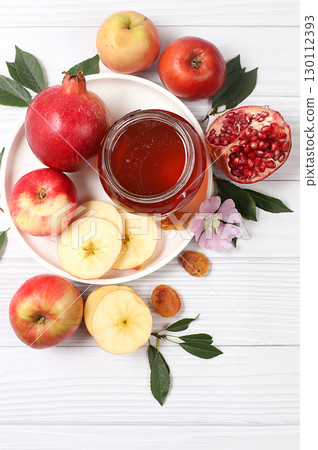 Apples, honey,pomegranate and dried apricots on a bright white wooden background,The concept of the Jewish holiday Rosh Hashanah top view with a place for your text,Jewish New Year and Apples, honey,pomegranate and dried apricots on a bright white wooden background,The concept of the Jewish holiday Rosh Hashanah top view with a place for your text,Jewish New Year and 130112393