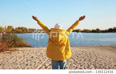 Happy woman on beach, enjoying amazing landscape, warm weather standing on sea coast Happy woman on beach, enjoying amazing landscape, warm weather standing on sea coast 130112416