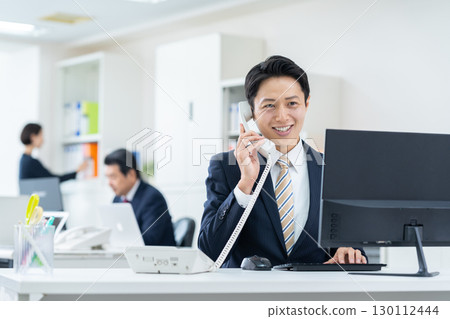 Middle-aged businessman working in the office Middle-aged businessman working in the office 130112444