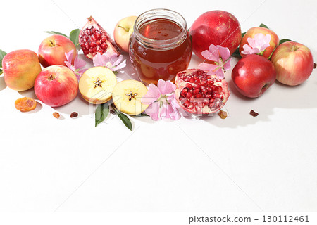 Autumn banner with honey, apples, pomegranates, flowers, dried fruits on a light background with place for text, composition for the Jewish holiday Rosh Hashan, Hello autumn and thanksgiving day 130112461