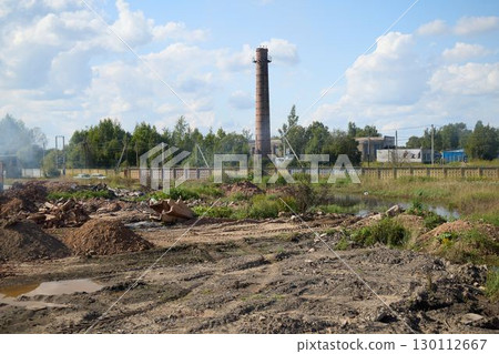 A detailed depiction of an Industrial Landscape featuring a Smokestack alongside a Construction Site 130112667