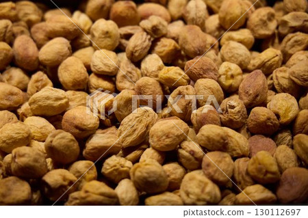 A CloseUp Look at a Vibrant, Colorful Display of Various Dried Nuts at a Market Stall A CloseUp Look at a Vibrant, Colorful Display of Various Dried Nuts at a Market Stall 130112697