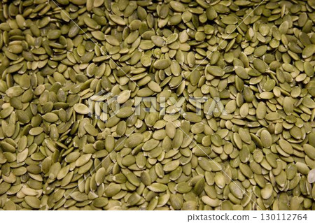 A CloseUp View of Green Pumpkin Seeds Ideal for Enjoying Healthy Snacking Options 130112764