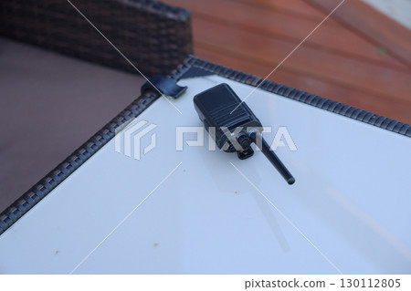 A compact walkietalkie is displayed elegantly on a flat table surface, ready for use 130112805