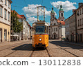 A photo of a tram running through a historic European city 130112838