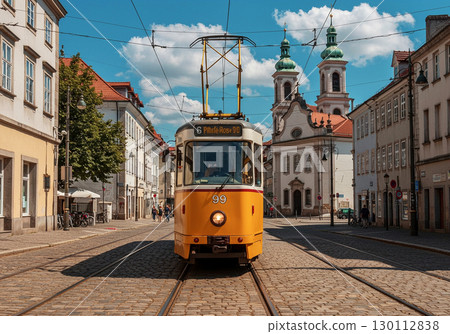 A photo of a tram running through a historic European city 130112838