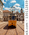 A photo of a tram running through a historic European city 130112839