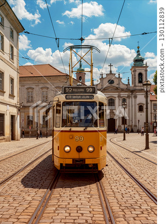 A photo of a tram running through a historic European city 130112839