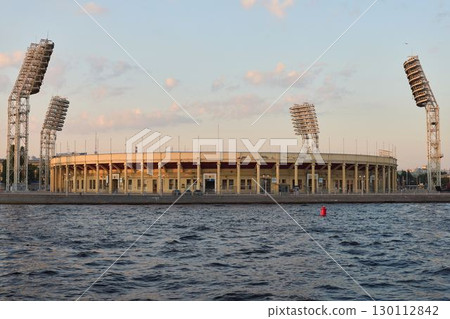 An amazing stadium situated by the water during the breathtaking golden hour display An amazing stadium situated by the water during the breathtaking golden hour display 130112842