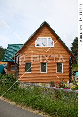 This Charming Wooden House Nestles Among Lush Nature and Colorful Flowers, a Perfect Retreat 130112874