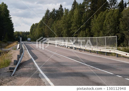 A Serene and Peaceful Roadside View, Beautifully Surrounded by Lush Greenery and Nature A Serene and Peaceful Roadside View, Beautifully Surrounded by Lush Greenery and Nature 130112948