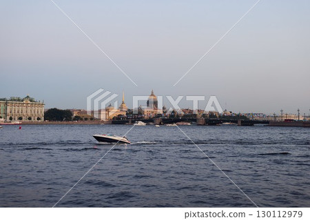 St. Petersburg offers a stunning evening view featuring a boat gliding across the shimmering water St. Petersburg offers a stunning evening view featuring a boat gliding across the shimmering water 130112979