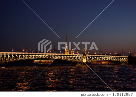 The St. Petersburg Bridge at Dusk Showcases Beautiful City Lights Illuminating the Scene 130112997
