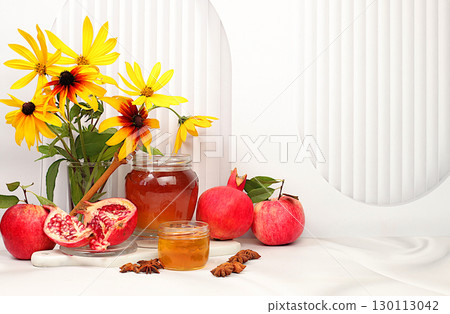 Autumn banner with honey, apples, pomegranates, flowers, dried fruits on light background, composition for Jewish holiday Rosh Hashanah, autumn and thanksgiving greeting concept, selective focus, with 130113042