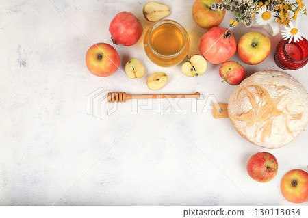 Autumn composition with apples, honey, pomegranate and flowers. Harvest concept and hello autumn, jewish new year rosh hashanah, eco food. Healthy food, body detox, selective focus, space for text 130113054