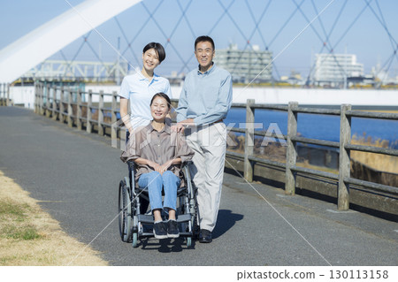 Woman in wheelchair and family 130113158