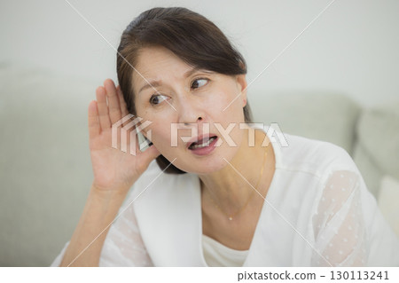 Senior woman with hearing loss 130113241