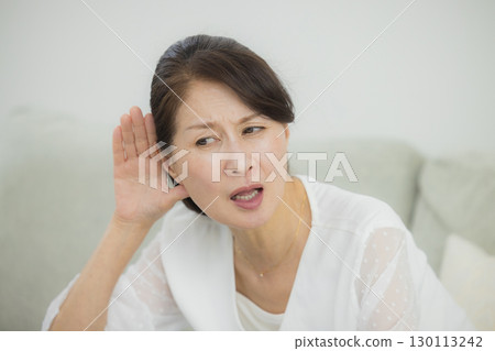 Senior woman with hearing loss 130113242