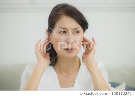 Senior woman with hearing loss 130113245