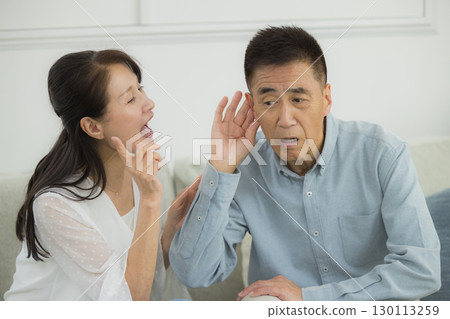 Senior couple in the living room 130113259