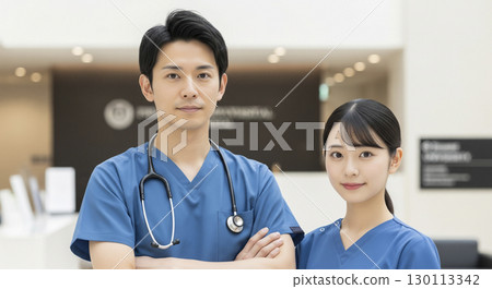 Male and female medical workers in a hospital lobby 130113342