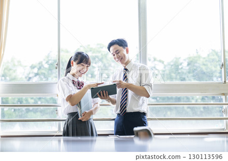 High school girl asking a question to her teacher High school girl asking a question to her teacher 130113596