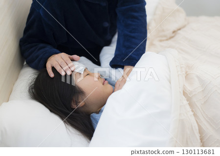 A mother and a girl with a fever A mother and a girl with a fever 130113681