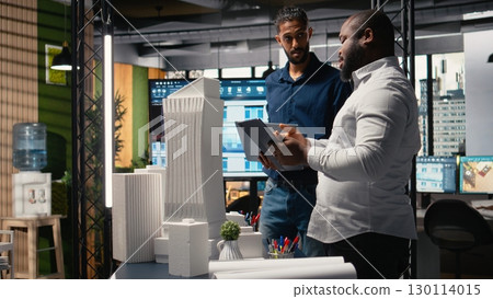 Real estate professionals evaluating property layout for site preparation, urban development and investment strategy for a large scale project. Infrastructure growth and housing. Real estate professionals evaluating property layout for site preparation, urban development and investment strategy for a large scale project. Infrastructure growth and housing. 130114015