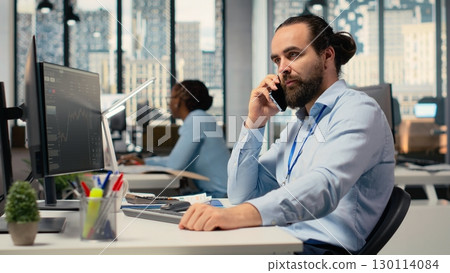 Financial advisor offers investment guidance during call with clients using smartphone. Investment consultant doing mobile phone call, helping customers build tailored portfolio 130114084