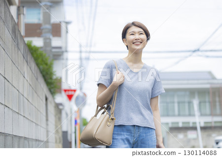 A woman walking in a residential area 130114088