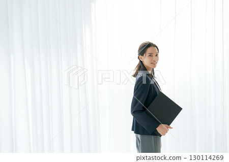 Portrait of a working woman in a suit 130114269