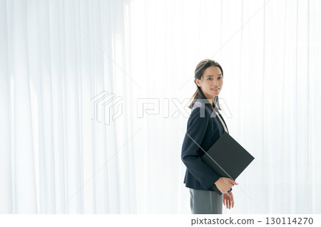 Portrait of a working woman in a suit 130114270