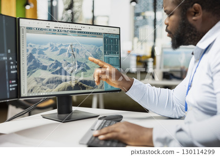 Close up of engineer analyzing advanced wind turbine models to improve efficiency and environmental performance. Designer creates innovative VAWT turbine in CAD software with higher clean energy yield Close up of engineer analyzing advanced wind turbine models to improve efficiency and environmental performance. Designer creates innovative VAWT turbine in CAD software with higher clean energy yield 130114299