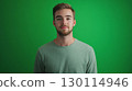 The backdrop is a vibrant green emphasizing their expressions 130114946