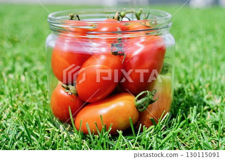 "Aiko" - a jar of fresh cherry tomatoes placed on the grass "Aiko" - a jar of fresh cherry tomatoes placed on the grass 130115091