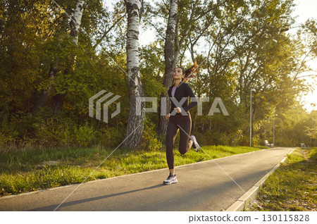 Female young runner jogging alone in city park. Healthy sporty fitness woman running outdoors. Female young runner jogging alone in city park. Healthy sporty fitness woman running outdoors. 130115828