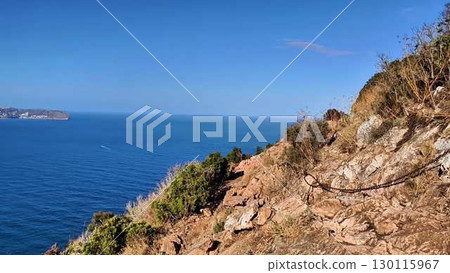 Breathtaking Scenic Coastal View from Cliff Edge Overlooking the Clear Blue Ocean Waves Breathtaking Scenic Coastal View from Cliff Edge Overlooking the Clear Blue Ocean Waves 130115967