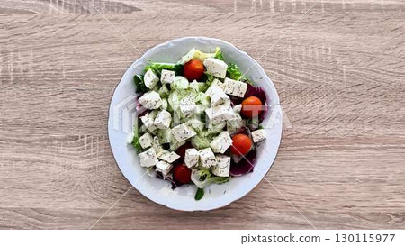 Delicious and Fresh Vegetable Salad made with Feta Cheese and Cherry Tomatoes for everyone 130115977
