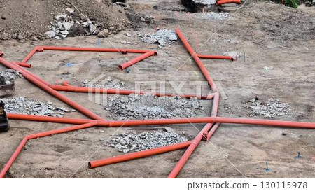 The network of red pipes at the busy construction site boosts overall efficiency and effectiveness 130115978