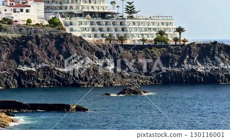 Experience the stunning and breathtaking view of a coastal resort with its rocky shoreline Experience the stunning and breathtaking view of a coastal resort with its rocky shoreline 130116001