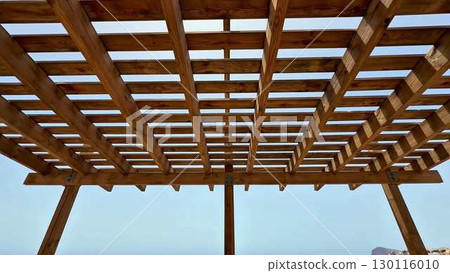 A Beautiful, Scenic Wooden Pergola That Offers a Stunning Overlook of the Seaside View 130116010