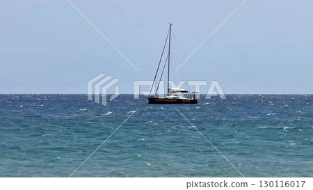 Sailing on a boat over the serene and tranquil waters of the vast ocean brings true peace and joy 130116017