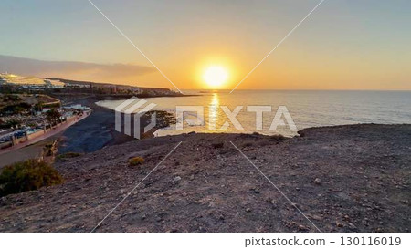 An absolutely stunning sunset view over the beautiful ocean along the rocky shoreline area An absolutely stunning sunset view over the beautiful ocean along the rocky shoreline area 130116019